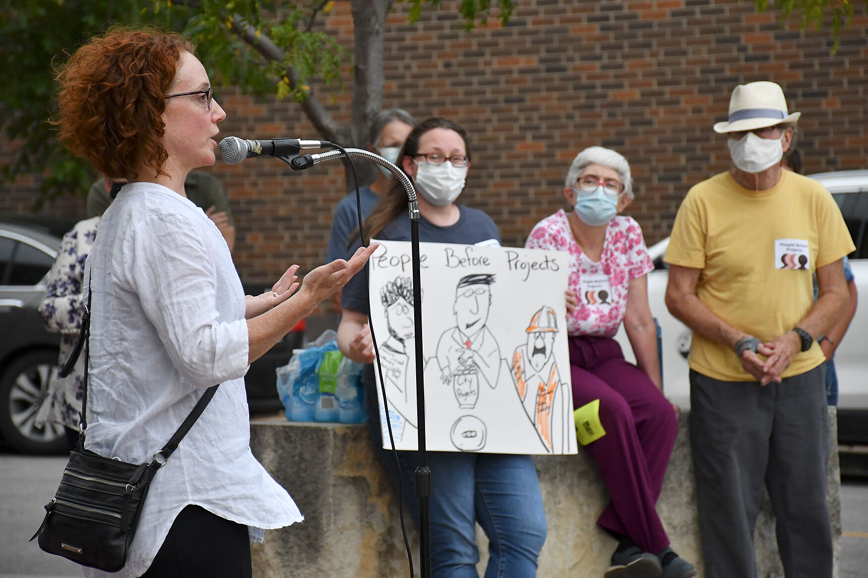 Activists watch as Renee Maxwell makes opening remarks of the People Before Projects rally